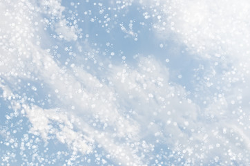 Falling snowflakes on  blue background