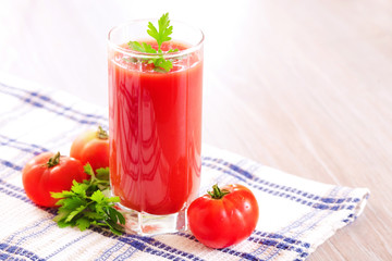 Glass of fresh tomato juice on the table
