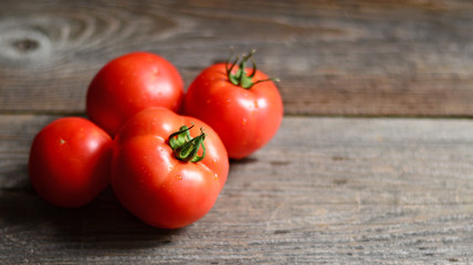 Fresh tomato on wooden background, closeup