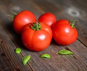 Fresh tomato on wooden background, closeup