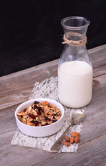Granola Cereal with bottle of milk on wooden table