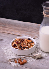Granola Cereal with bottle of milk on wooden table