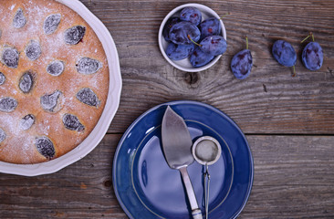Plum cake on wooden background, close up