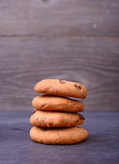 Chocolate cookies on black table. Stacked chocolate chip cookies