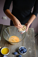 Baking: Woman prepare the eggs for butter and flour, and finally