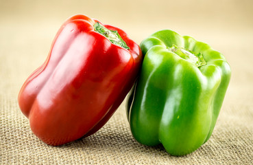 Green and red capsicum on burlap wrap