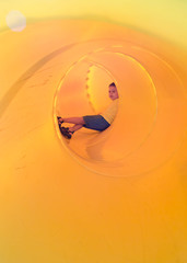 happy kid in a tube slide