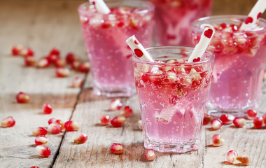 Pink cocktails for Valentine's Day with pomegranate seeds and tu