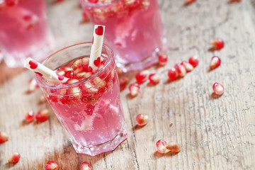 Pink cocktails for Valentine's Day with pomegranate seeds and tu