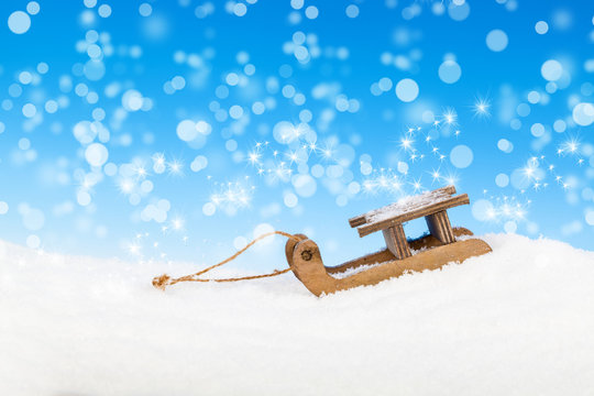 Old vintage wooden sled on blue background