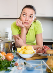 Confused housewife at kitchen