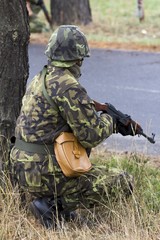 Fototapeta premium soldier in a camouflage suit fights