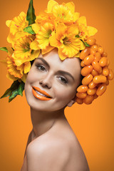 Girl with orange tomatoes and flowers