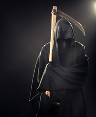 death with scythe standing in fog at night
