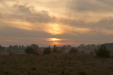 Fototapeta na wymiar Foggy Evening Before Sunset in Countryside in Autumn