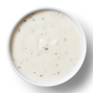 Round white bowl of tortilla sour cream dip isolated from above.