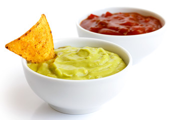 Round white bowl of guacamole dip isolated in perspective. Torti