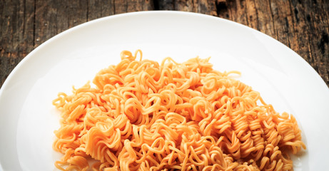Noodle on white plate put on old wooden table