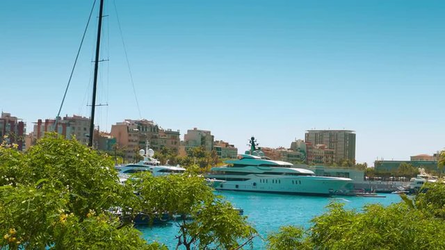 Luxury yacht and apartment buildings establishing shot
