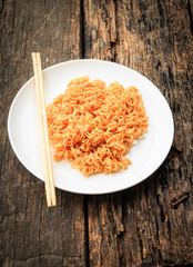 Noodle on white plate put on old wooden table