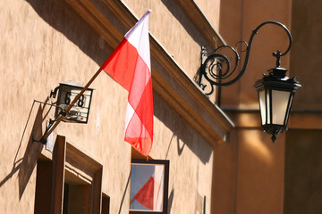 Polish flag and lantarn in background