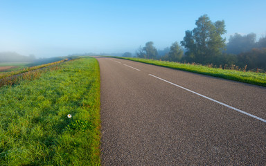Road through a hazy sunny landscape