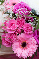 Gorgeous bouquet with pink roses and daysies (Gerbera) and white Chrysanthemum flowers on grass