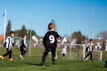 Foto op Plexiglas Young boy during soccer match © Mikkel Bigandt