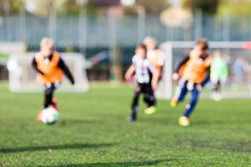 Obraz na płótnie Canvas Blur of young boys playing soccer match