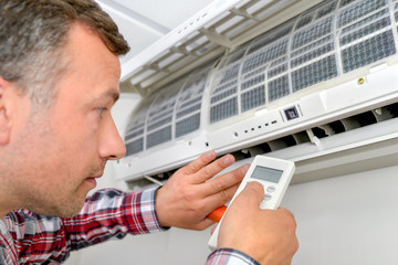 Man repairing air conditioning unit