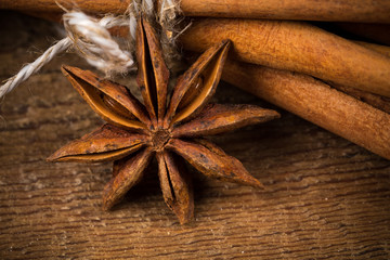 Close up of cinnamon sticks and star anise on wood