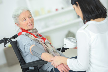 Fototapeta premium Checking an old lady's blood pressure