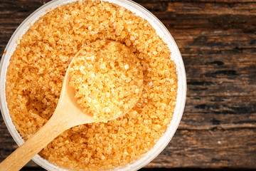Brown sugar close-up on wooden spoon