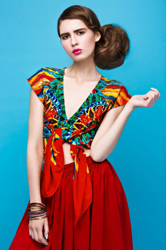 Beautiful fashionable woman an unusual hairstyle in bright clothes and colorful accessories. Cuban style.