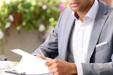 Handsome businessman making notes 