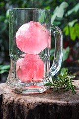 Raspberry flavour ice in soda water decorated with rosemary
