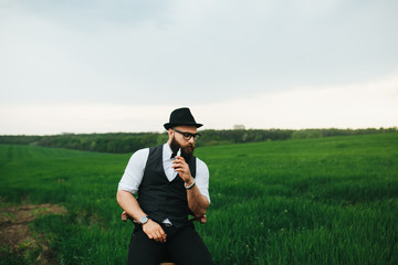 man with a beard, thinking in the field