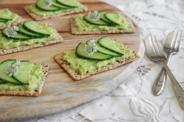 Green cucumber and avocado wholegrain rectangle crackers with co