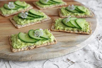 Green cucumber and avocado wholegrain rectangle crackers with co