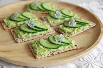 Green cucumber and avocado wholegrain rectangle crackers with co