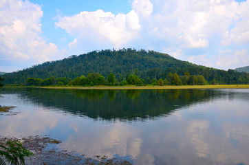Fototapeta na wymiar Lake scene with reflections of the hills and sky