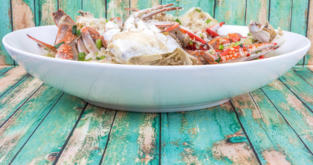 Malaysian dish clear crab soup in an oblong plate over wooden background - obrazy, fototapety, plakaty
