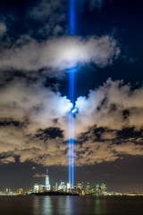 Obraz premium September 11 commemoration with the Tribute in Light, New York City. Two columns of light illuminate the sky over Lower Manhattan near the One World Trade Center skyscraper