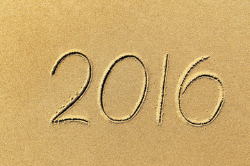 2016 year written on the beach sand