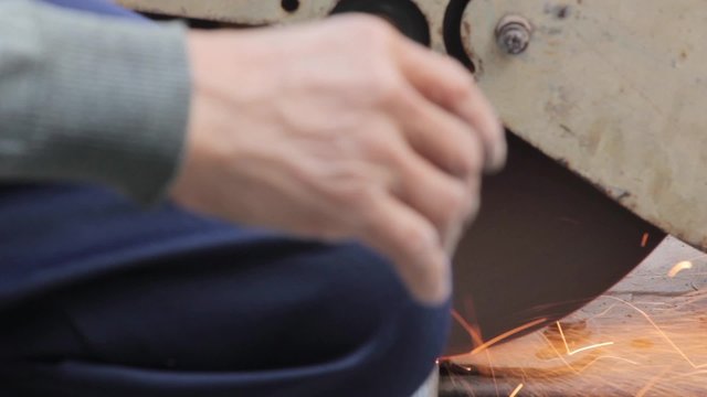 cutting a metal pipe with steel cutter with hand holding without gloves