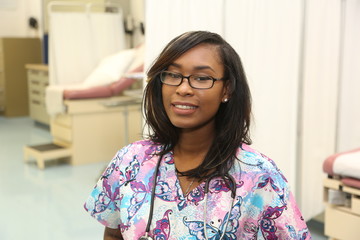 Young attractive African American Female nurse in hospital examination room