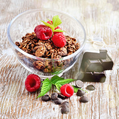 Chocolate granola, and raspberries, muesli for healthy breakfast, toned image