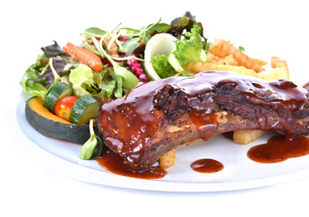 Rib steak served with salad on white background
