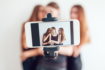 Beautiful young girls taking a photo with selfie stick
