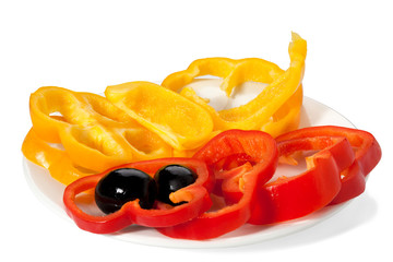 olives and slices of bell pepper red and yellow on a white plate